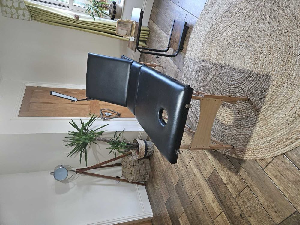 The treatment room at Glebe Farm: a single couch, a wooden floor and daylight from one side
